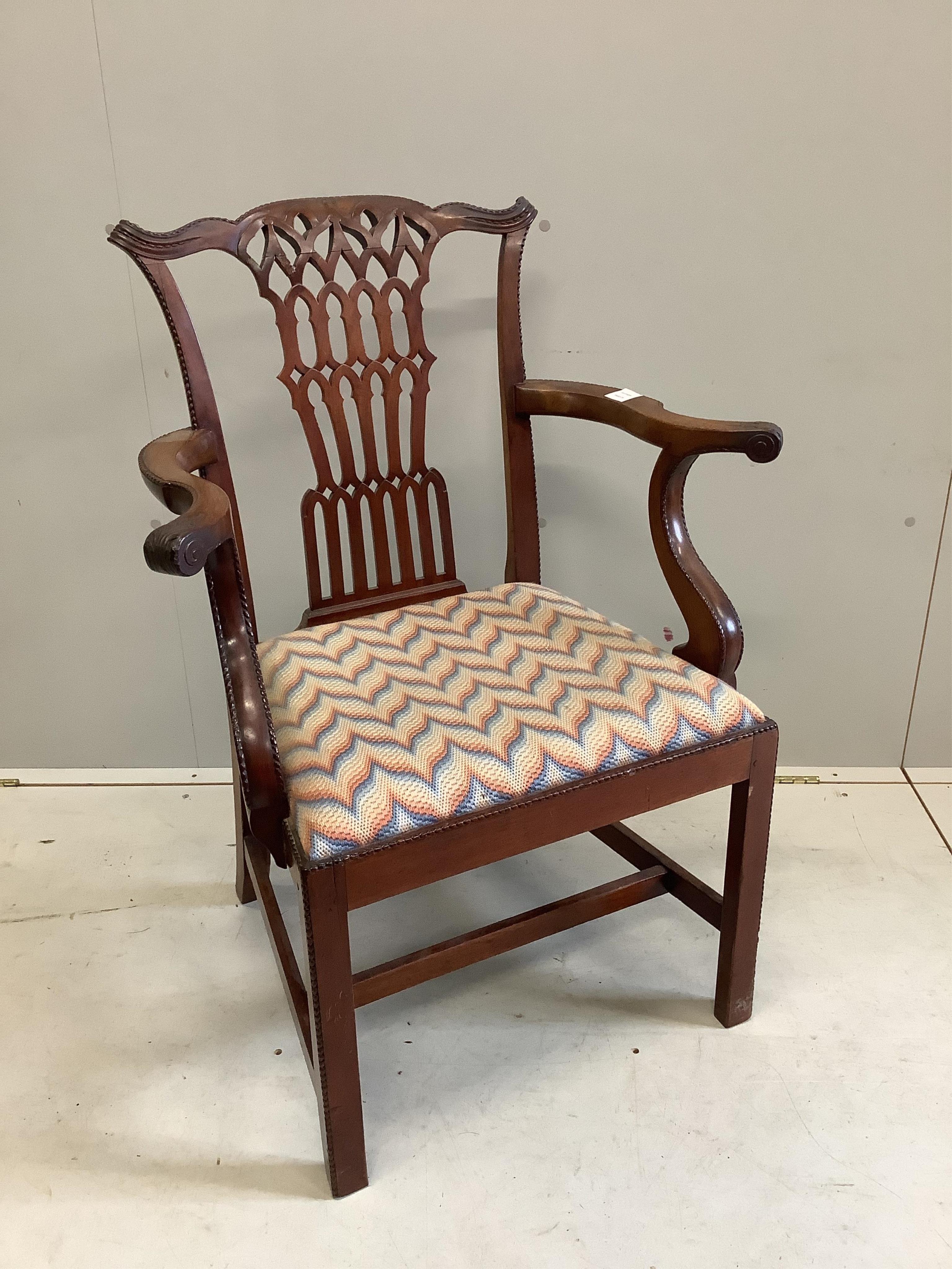 A George III mahogany elbow chair, with shaped arms and a pierced splat, width 70cm, depth 47cm, height 94cm. Condition - fair